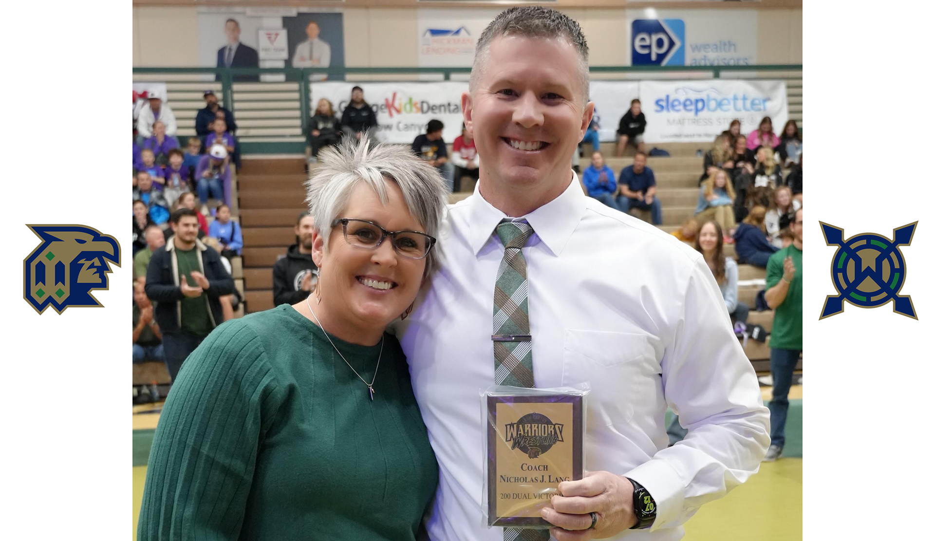 Coach Land and wife hold award